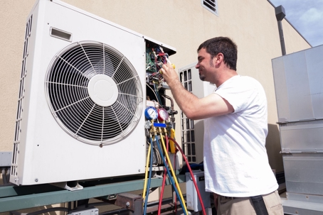 man fixing hvac system